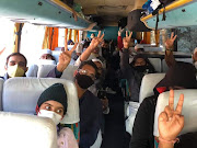 South Africans who were stranded in India for months landed in Johannesburg on Sunday night. Here they are pictured taking a bus to the airport in India.