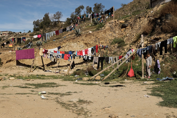 Clothing dries at a makeshift migrant camp in Tijuana, Mexico, on Tuesday, February 8, 2022. The number of migrants detained in Mexico surged 78% in January from a year ago, Mexico’s National Immigration Institute reports.