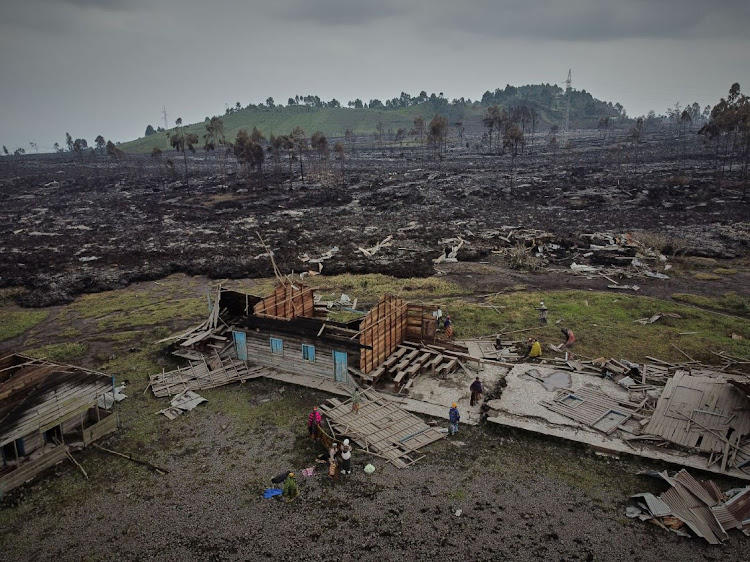 People prepare to evacuate from recurrent tremors after homes were covered with lava by the eruption of Mount Nyiragongo near Goma in the DRC, taken on May 25 2021. Picture: HANDOUT VIA REUTERS/SAVE THE CHILDREN/HUGH KINSELLA CUNNINGHAM