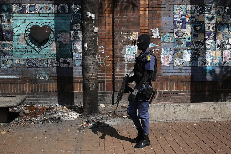 Policeman walks through downtown Johannesburg CBD.