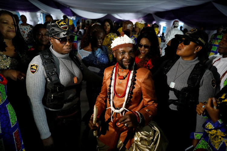 Esther Brown and Ukeme Tom, 37, members of the female-only security team Dragon Squad Limited, guard newly crowned king Obong Ibanga Ikpe at his coronation ceremony in Uyo, Akwa Ibom, Nigeria, October 29, 2022.