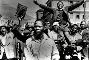 A young Philip Kgosana is carried shoulder-high by marchers in March 1960.