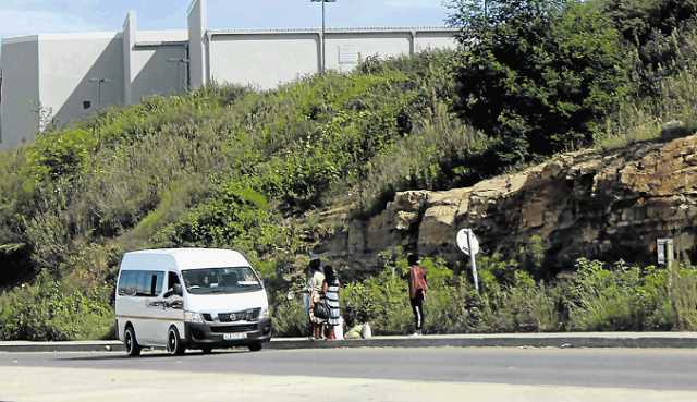 A taxi stops for hitchhikers along the forbidden R61 route near the Mthatha Circus Triangle mall.