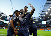 Rodrygo celebrates scoring for Real Madrid with Vinicius Junior and teammates in their Champions League quarterfinal second leg penalties win against Manchester City at Etihad Stadium in Manchester on Wednesday night.