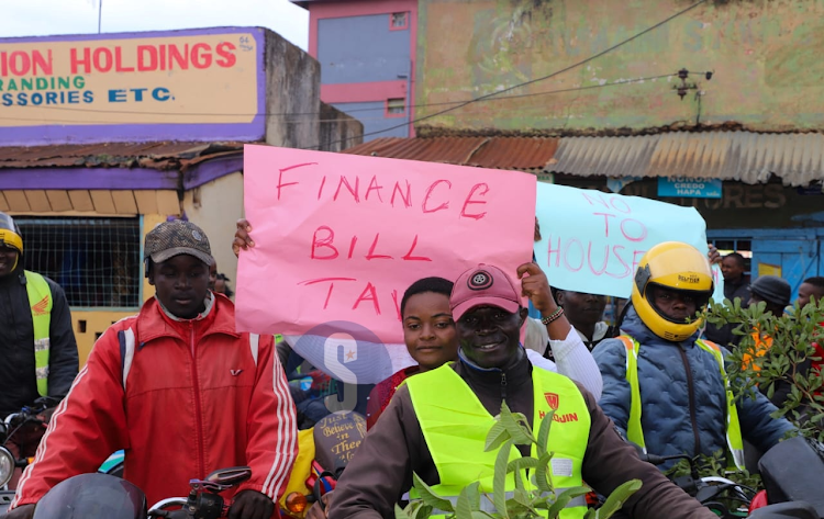 Demonstrators carrying placards in Luanda Town during the Saba Saba protests in July 7, 2023.