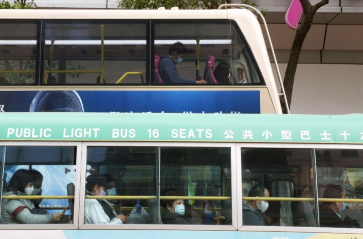 Commuters wearing face masks following the coronavirus disease (COVID-19) outbreak, ride public buses in Hong Kong, China February 8, 2022