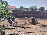 Prasa's Gauteng infrastructure team at the site where the bridge collapsed clear the railway line and remove parts of the bridge. 