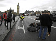 A victim lies on the road in the aftermath of this week's attack on Westminster Bridge by a lone British-born terrorist.