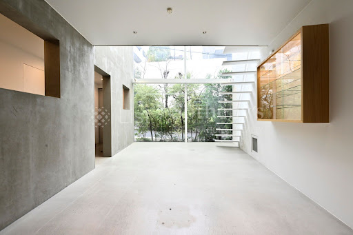Modern interior with floating staircase and concrete walls in this luxury house for sale in Minato City ($3,136,208)