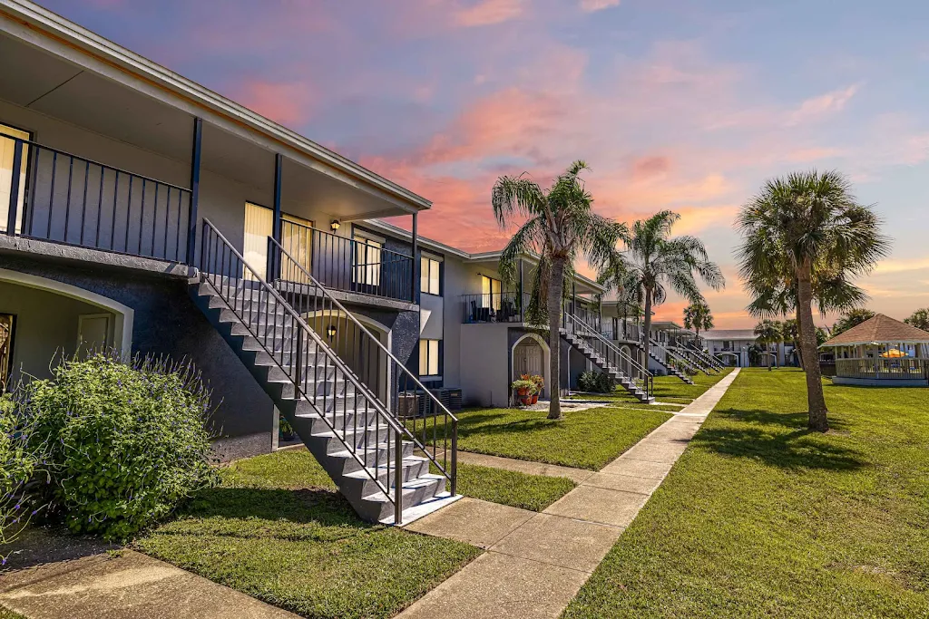 The Park at Topaz Cay two-story building with green area and trees out front