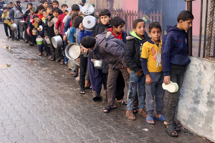 Palestinian children queue for food in Rafah, the Gaza Strip, December 14 2023. Picture :SALEH SALEM/REUTERS