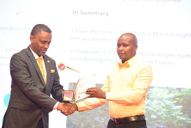 Environment reporter Gilbert Koech receiving the award.