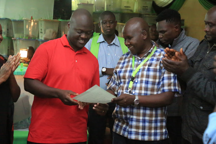 Kitutu Chache South MP-elect Anthony Kibagendi receives his certificate after he was declared winner by returning officer David Cherop.