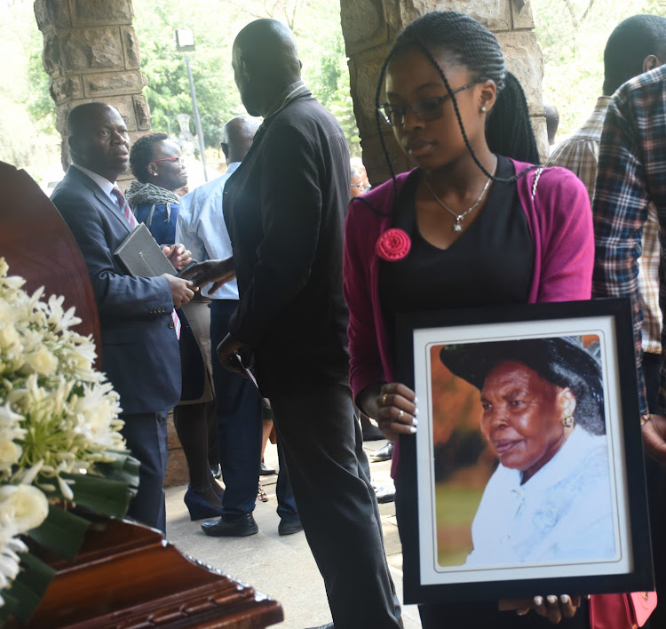 Nicole Muswanya holds her grandmother's portrait photo