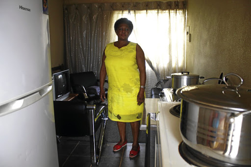 Elizabeth Mapanzela the sister of the deceased, Simon Madiehe, insert, inside the house of their brother in Potchefstroom.