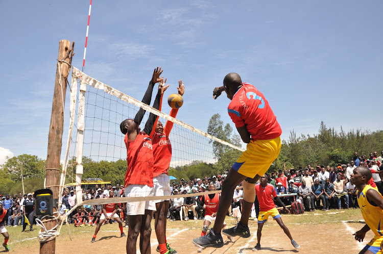 Cheptil’s Kipkemboi Alfred spikes the ball against through Western region’s representative Nabwera High yesterday at Kakamega HighSchool's grounds.