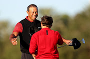 Tiger Woods and son Charlie Woods hug on the 18th hole after the final round of the PNC Championship, a tournament where professional golfers can partner family members, at Ritz-Carlton Golf Club in Orlando, Florida on December 18 2022. Woods' return to golf in 2022 from a horror car crash was overshadowed by the fracas between the PGA Tour and breakaway LIV Golf.