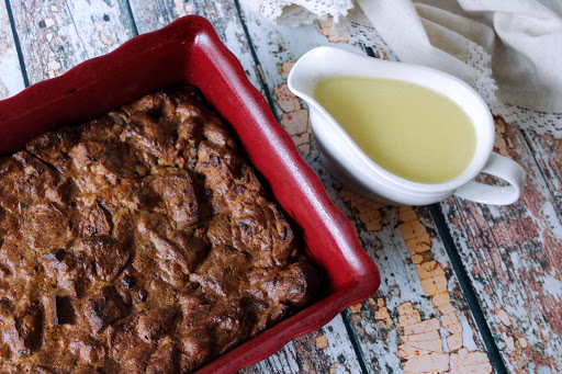 Cranberry walnut bread pudding with sauce.