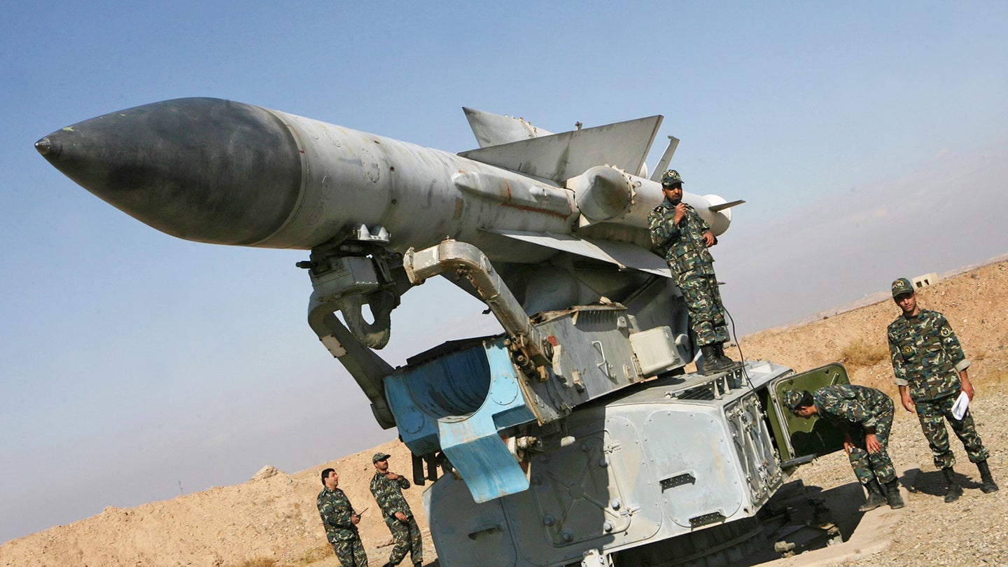 Iranian soldiers stand near a S-200 surf