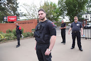 Security stand at the gates of Maritzburg College‚ a public school for boys. File photo 