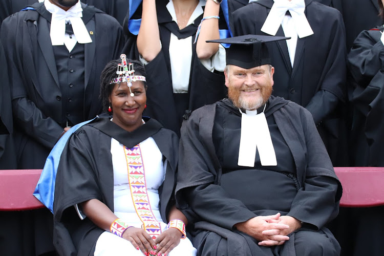 Nkamnu Patita sits with Praelector of Wolfson College, David Goode on October 21, 2023, during her graduation in the UK.