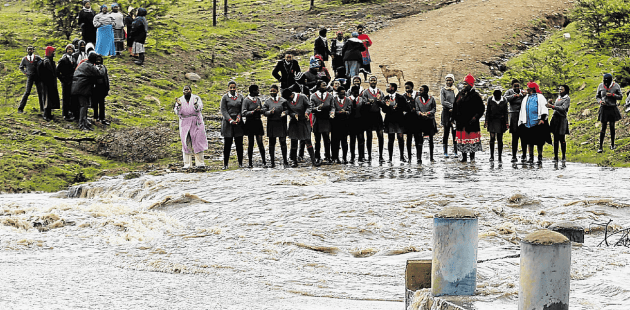 Pupils in Qaga village in King William’s Town are trapped by the raging stream, which has flooded the bridge.