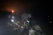 People collects their belongings after their shacks were burnt by fire at Dakota Informal Settlement  in Isipingo.