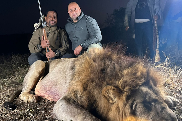 King Misuzulu kaZwelithini and a professional hunter pose with a three-year-old male lion which they shot at Mkuze Falls Game Reserve, KwaZulu-Natal, on Thursday night.