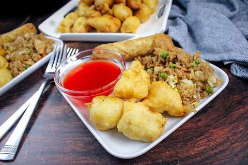 Chicken Bites Tempura Style with fried rice and sweet and sour sauce.