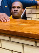 Convicted rapist Prince Thokozane Mazibuko, 34, is led down to holding cells after being sentenced.
