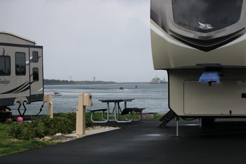 A trailer parked on the side of a road next to a body of water

Description automatically generated with low confidence