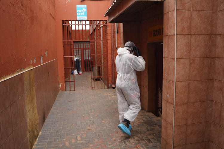 Saaberie Chishty paramedic Michael Makhethe arrives at a Lenasia block of flats after receiving a call about a patient displaying Covid-19 symptoms.