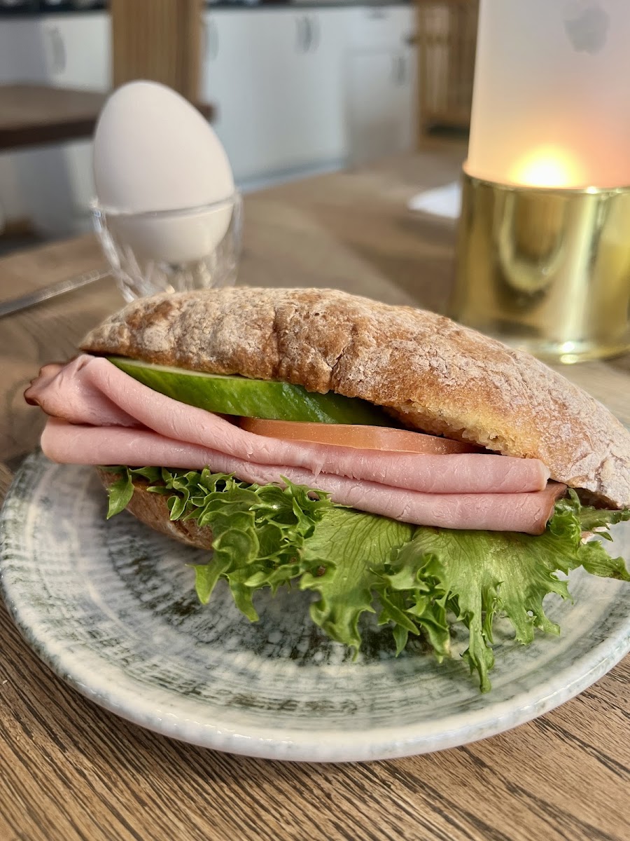 Breakfast sandwich and boiled egg.