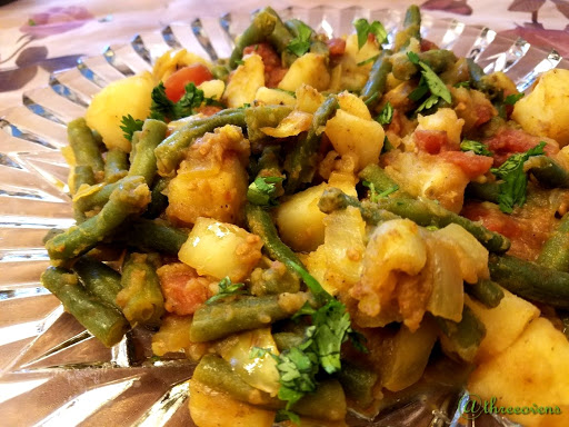 Potatoes with Green Beans on a clear plate.