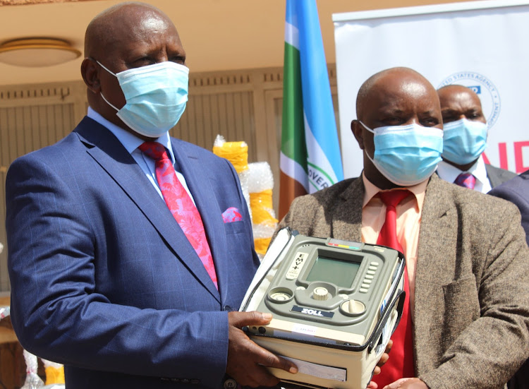 Nyeri Governor Mutahi Kahiga receives a ventilator from USAID representative Peter Waithaka outside his office in Nyeri town. USAID donated 14 ventilators.