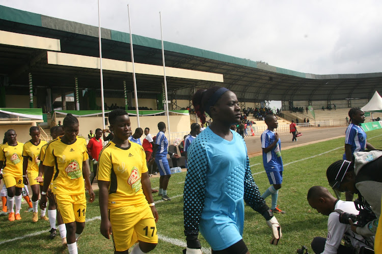 Nairobi's Acakoro girls team (in blue) and the Ndhiwa from Nyanza (Yellow) from their changing rooms to Kinoru Stadium during the second edition Chapa Dimba Na Safaricom in Meru on June 20. Acakoro beat Ndhiwa 3-2.