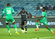 Justin Shonga of Orlando Pirates is challenged by Mzwanele Mahashe and Tshepo Rikhotso of Bloem Celtic during their Absa Premiership  match on Tuesday. /BackpagePix / Samuel Shivambu