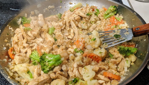 Frozen veggies and riced cauliflower is cooked in the same skillet as chicken strips for a great dinner that feeds 6. One of our favs!