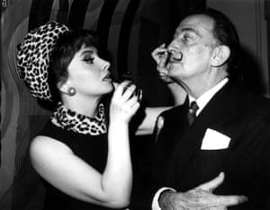 Gina Lollobrigida prepares to photograph Salvador Dali in his studio at the St. Regis hotel in New York, which adjoined his suite, on 15 June 1955