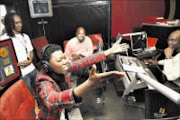 HONOURED: Lira is overcome with emotions at Kaya FM studios. With her are the station's MD Greg Maloka and T-Bose. Pic: Antonio Muchave. 04/06/2009. © Sowetan