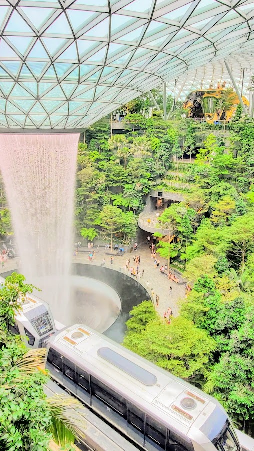 Visiting Changi Airport in Singapore: You can get a glimpse of Jewel without exiting post-security by riding the Skytrain between Terminal 2 and 3 since it passes through Jewel's center including a glimpse of the famous HSBC Rain Vortex and the surrounding Shiseido Forest Valley