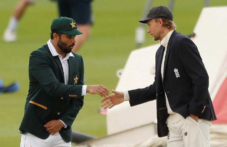 Pakistan's Azhar Ali shakes hands with England's Joe Root after the coin toss ahead of the first Test at Emirates Old Trafford, Manchester on August 5, 2020