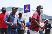 Striking Clover workers sing struggle songs outside the Clayville distribution centre in Olifantsfontein, Ekurhuleni. They are protesting against restructuring and a retrenchment process. File image