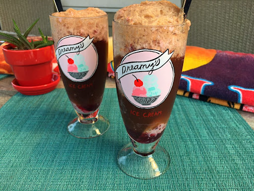 Two tall ice cream soda glasses of tasty Cherry Cola Float.