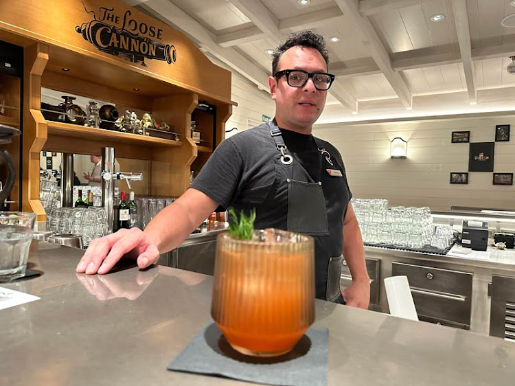 Mixologist Manny Gutierrez with his cocktail concoction Risc.