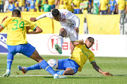 Grant Kekana of Mamelodi Sundowns makes a challenge at the feet of Swallows FC's Evans Rusike in the DStv Premiership match at Dobsonville Stadium on April 9 2023. 