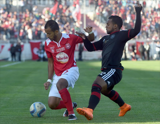 A file photo of Etoile du Sahel's Hamza Lahmar (L) ias he is defended by Orlando Pirates' Kermit Erasmus (R) during the second final of the 2015 CAF - Confederation of African Football Cup match between Tunisia's Etoile du Sahel and South Africa's Orlando Pirates at the Sousse Olympic stadium on November 29, 2015.
