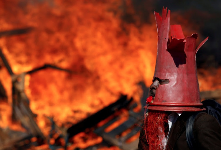 A supporter of the opposition Movement for Democratic Change party (MDC) of Nelson Chamisa wears a cone as they block a street in Harare, Zimbabwe, August 1, 2018.