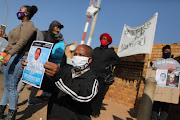 Community members picket outside the Protea Magistrate's Çourt in Soweto where two police officers are set to appear in connection with the death of Natheniël Julies. 