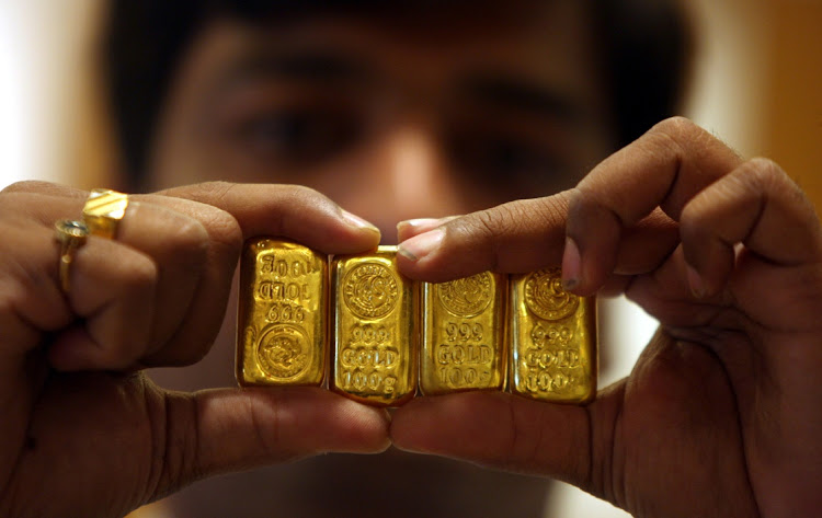 A salesman displays gold bars in Hyderabad, India. Picture: REUTERS/KRISHNENDU HALDER